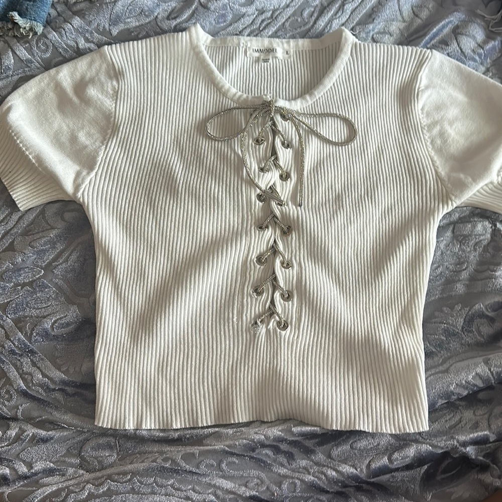 Large, white, laced t shirt.